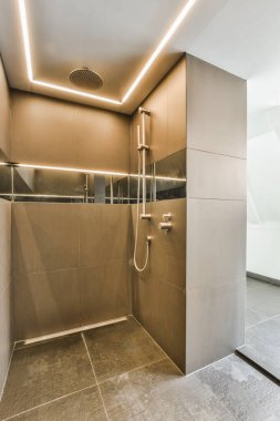 Shower faucets attached to tiled wall