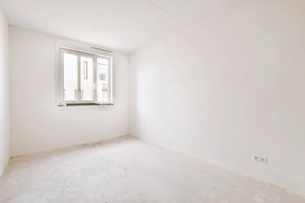 Plastic window and white wall in empty light room at home