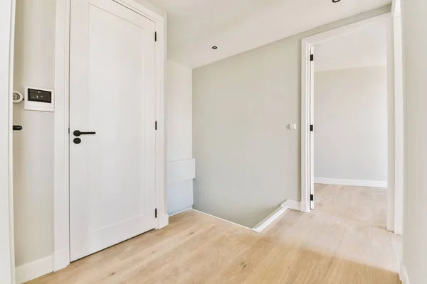 Interior of contemporary flat in minimal style with spacious hallway with white walls