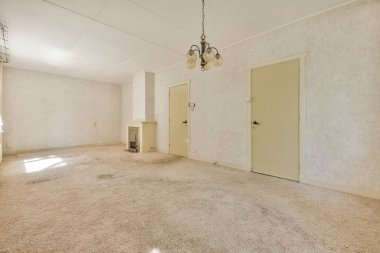 Plastic window and radiator in empty light room at home