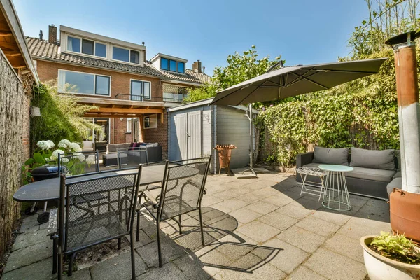 Neat powerful patio with sitting area and small garden