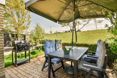 Neat powerful patio with sitting area and small garden