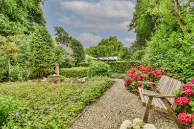 Neat powerful patio with sitting area and small garden near wooden fence