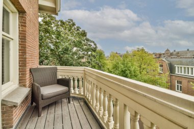 Panoramic view of old brick buildings with trees from small balcony