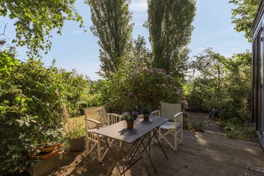 Neat powerful patio with sitting area and small garden