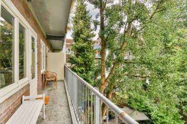 Sitting area in balcony with comfortable furniture around beautiful view