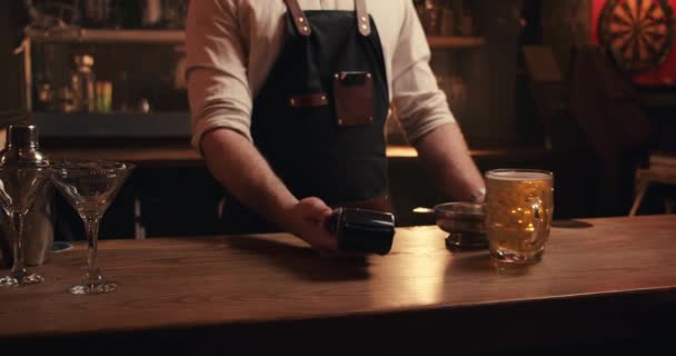 Caucasian bartender holding card machine while customer pays with cellular device — Video Stock