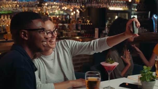 Diverso grupo de amigos tomando selfies en el restaurante juntos — Vídeos de Stock