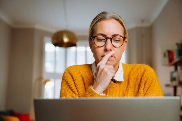 Caucasian female working from home on laptop — ストック写真