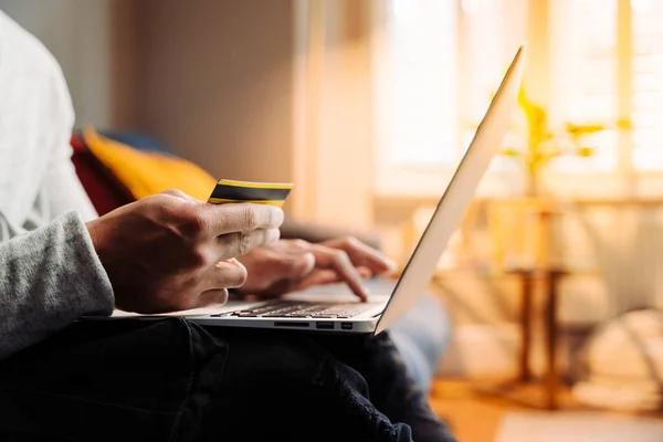 Close up of male on laptop making payments — 图库照片