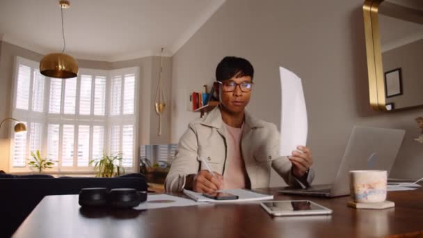Азиатский мужчина читает документ на дому и успешно завершает работу — стоковое видео