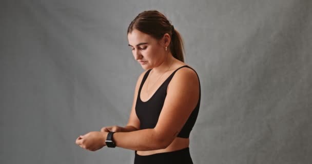 Giovane Femmina Caucasica Attraente Che Regola Suo Cinturino Smartwatch Guardando — Video Stock
