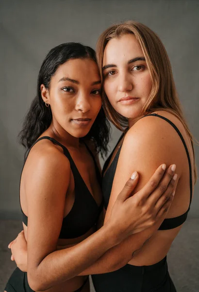 Close Two Focused Female Girlfriends Standing Studio Embracing Underwear High — Φωτογραφία Αρχείου
