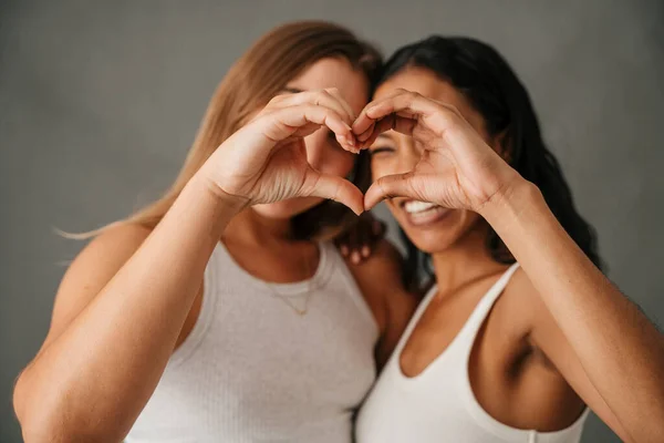 Portrait Two Happy Smiling Females Making Heart Shape Hands High — Stockfoto