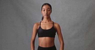 Female mixed race folding her arms with her fit bit watch on looking serious. High quality 4k footage