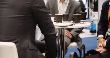Work colleagues having business meeting taking notes in there diarys on there cellphones having coffee . High quality 4k footage