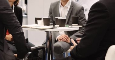 Business executives having business meeting taking notes and using there cellphones having coffee . High quality 4k footage