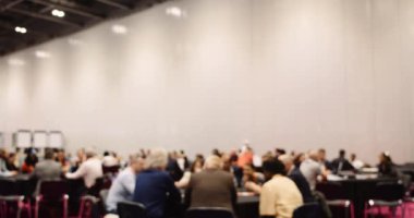 Conference center venue very full of people sitting at tables working on there laptops . High quality 4k footage