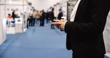  Close up of professional business person working on the cell phone in the conference center. High quality 4k footage