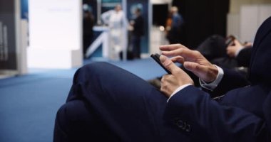 Close up of male executive wearing a suit working on his cellphone . High quality 4k footage