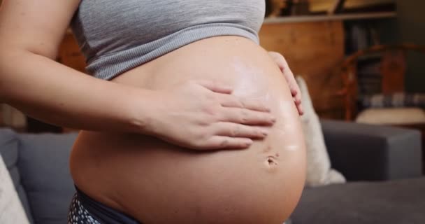 Young Pregnant Female Putting Cream Her Baby Bump Rubbing Her — Video