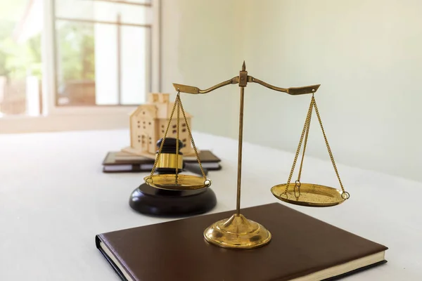 Gold brass balance scale isolated on book, Symbol of law and justice.