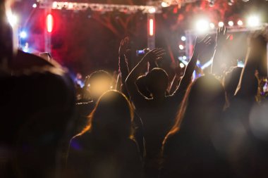 Audience take a photo on mobile phone at a free night concert music festival.