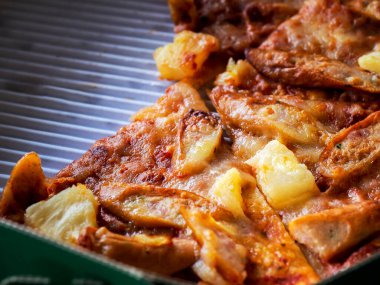 Close up of thin and crispy Pizza in a delivery cardboard box