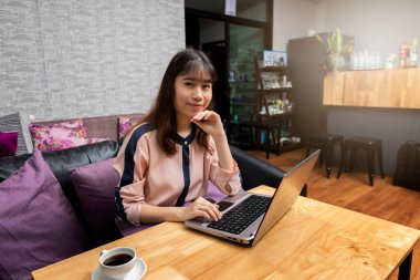 Happy successful Young beautiful Businesswoman with a laptop at home
