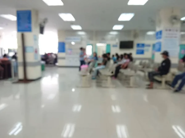 blurred background of Out Patient Department(OPD) of a hospital with patients.