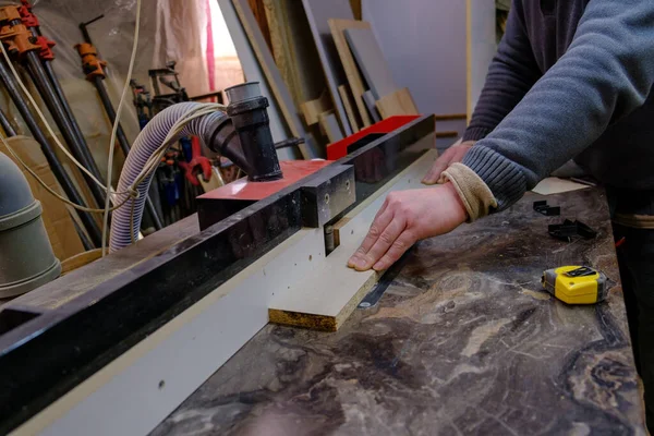 Mens hand sawing wood on circular saw, machine which saw wood, particle Board and fiberboard, production of furniture, selective focus — стоковое фото