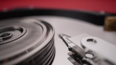 Rotating disks of a disassembled hard drive. Mirror surface of a computer drive Close-up Slow motion