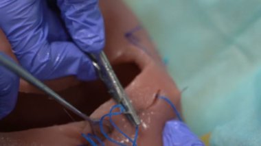 Training for surgeon students on mannequins. The female uterus is sutured with medical instruments