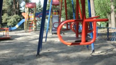 Empty swings at the playground in the park