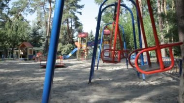 Empty swings at the playground in the park