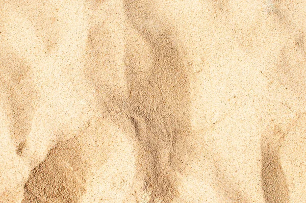 Tekstura piasku morskiego w słońcu z cieniami — Zdjęcie stockowe