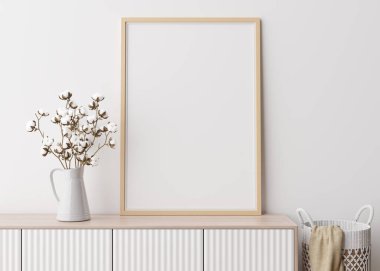 Modern oturma odasındaki beyaz duvara boş dikey resim çerçevesi. İç mekan minimalist, İskandinav tarzı. Resim için boş yer var. Konsol, rattan sepet, vazoda pamuk bitkisi. 3B görüntüleme