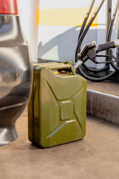 Refilling canister with fuel on the petrol station. Close up view. Fuel, gasoline, diesel is getting more expensive. Petrol industry and service. Petrol price and oil crisis concept. — Stock Photo, Image