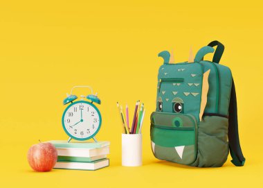 School stationery items on yellow background with free space for text. Creative, colourful background with school supplies. Layout with copy space. School bag, backpack, pencils, books. 3D rendering
