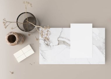 White book cover mock up with coffee cup, vase and other home accessories on beige table. Blank template for your design. Top view, close-up. Book, catalogue or magazine cover presentation. 3D render