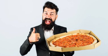 Pizza kutusundaki gülümseyen iş adamı başparmağını kaldırdı. İtalyan pizzalı takım elbiseli adam. Fast food. İş yemeği..