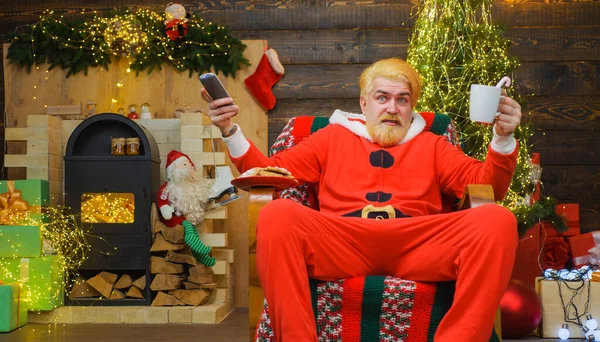 Санта Клаус сидит в кресле и пьет кофе. Счастливого Рождества. Новогодняя реклама. — стоковое фото