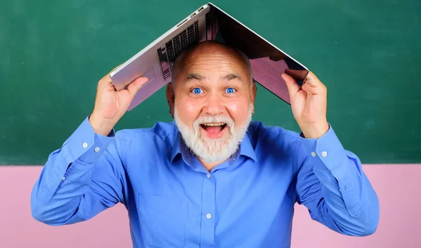 满脸胡须，头戴笔记本电脑的快乐男人。在课堂上用笔记本笑老师. — 图库照片