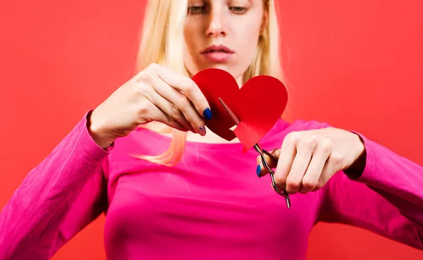 Girl with broken heart. Break of relationships. Sad woman cutting heart shape paper. Selective focus. — Stock Photo, Image