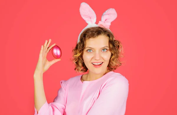 Охота на яйца. Счастливой Пасхи. Улыбающаяся женщина в кроличьи уши с розовым яйцом. Девочка-кролик. Весенние каникулы. — стоковое фото