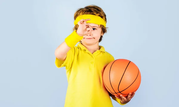 Sporty kid boy with basketball ball showing okay sign. Sport for children. Little basketball player. — Stock Fotó