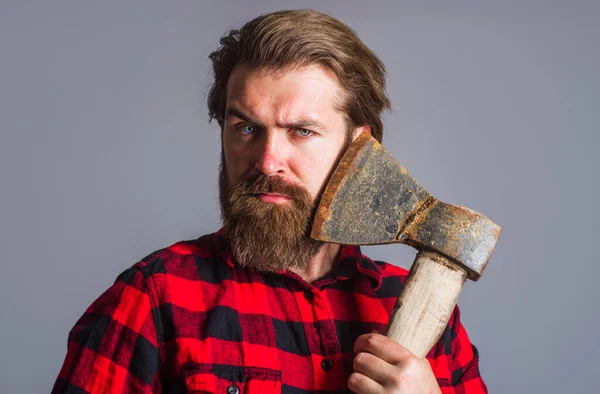 Bearded man with axe. Logger tool. Guy in checkered shirt with hatchet. Canadian lumberjack with ax. — Stock Fotó