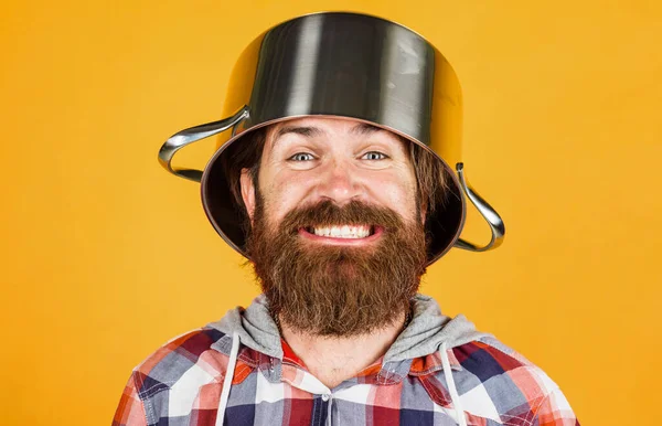 Kitchenware. Cooking utensil for food preparation. Kitchen cookware. Crazy chef with pot on head.