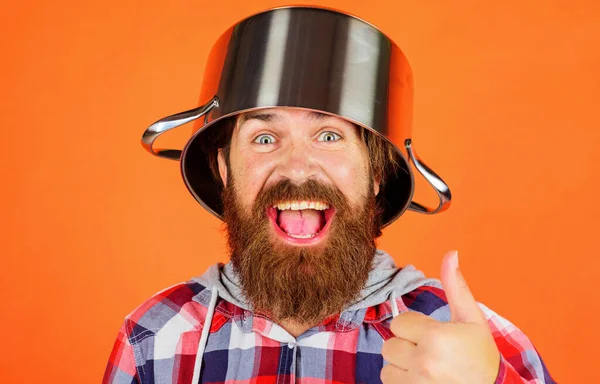 Bearded man with pot on head showing thumb up. Kitchenware. Cooking utensil for food preparation. — ストック写真