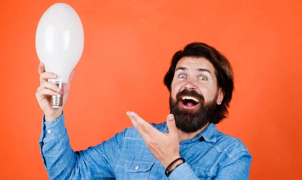 Smiling man with light bulb. Energy and electricity. Disposal Service. Innovation and inspiration. — Stock Fotó